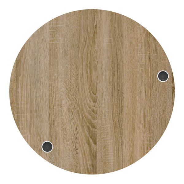 A BFM Seating round wood tabletop with two wireless chargers.