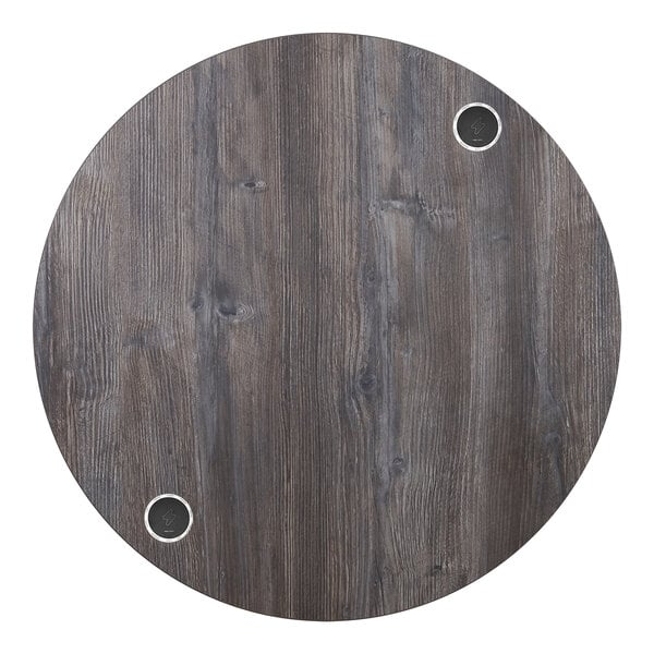 A BFM Seating round wood tabletop with two wireless charger holes.