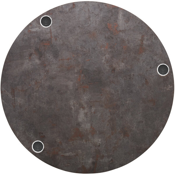 a circular metal surface with holes