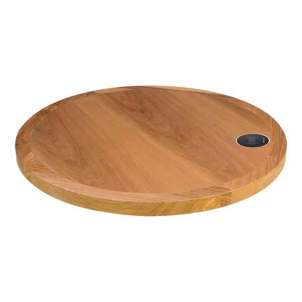 A BFM Seating round wooden table top with a wireless charger.