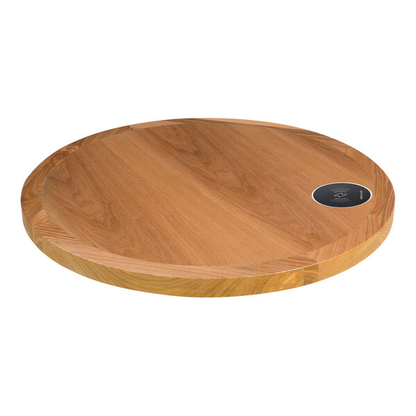 A BFM Seating round wood table top with a wireless charger.