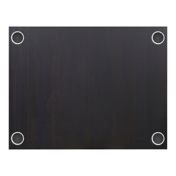 A black rectangular BFM Seating tabletop with round wireless charger holes.