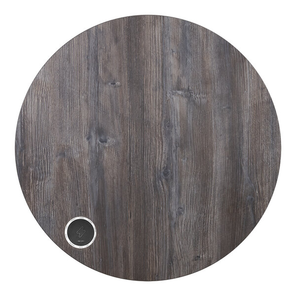 A BFM Seating Midtown round wooden table top with a circular logo on it.