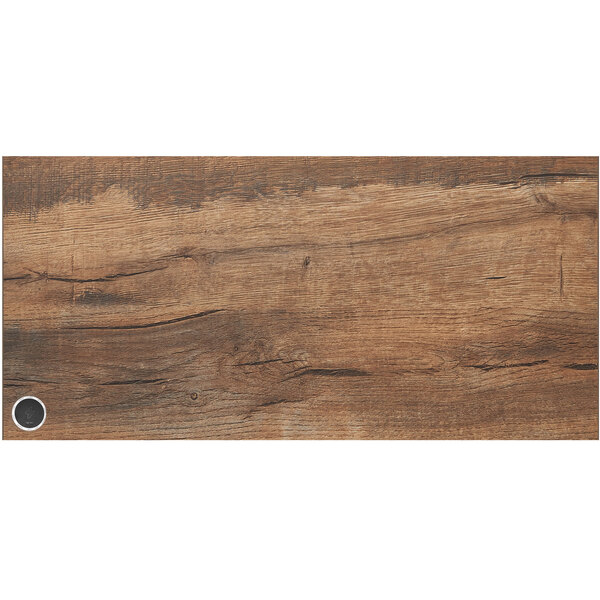 A knotty pine BFM Seating table top with a wireless charger.