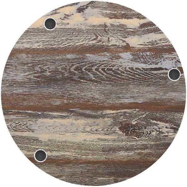 A BFM Seating Relic round wood table top with wireless charger holes.