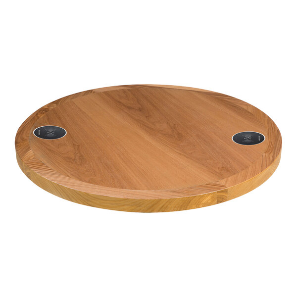 A BFM Seating round wooden table top with two circular charging areas.