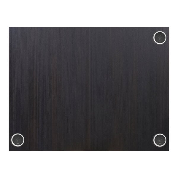 A black rectangular BFM Seating tabletop with round holes in a black wood surface.