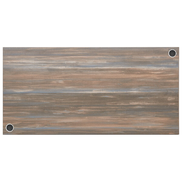A wood table top with a chestnut finish and wireless chargers.