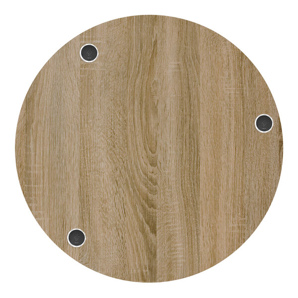 A BFM Seating round wooden table top with wireless chargers.