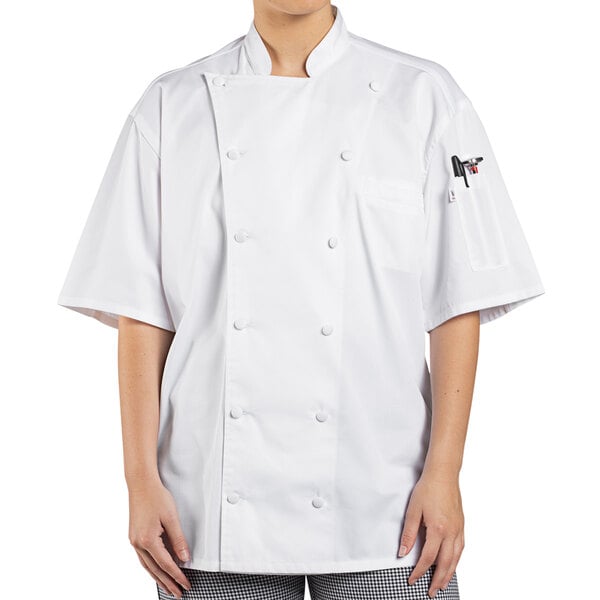 A woman wearing a white Uncommon Chef short sleeve chef coat with mesh back.