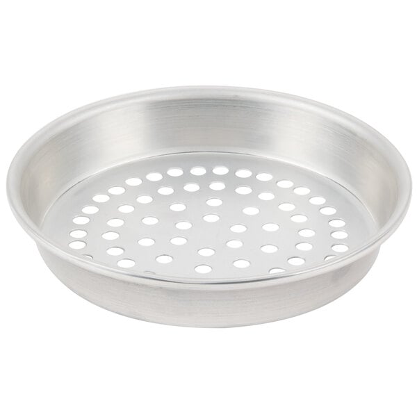A silver round metal pan with holes.