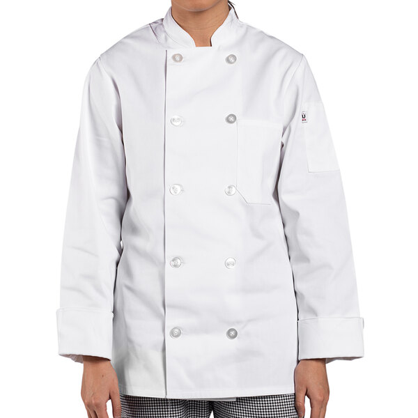 A woman wearing a white Uncommon Chef long sleeve chef coat.