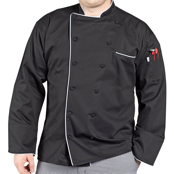 A man wearing a Uncommon Chef black chef coat with white piping over a white shirt.
