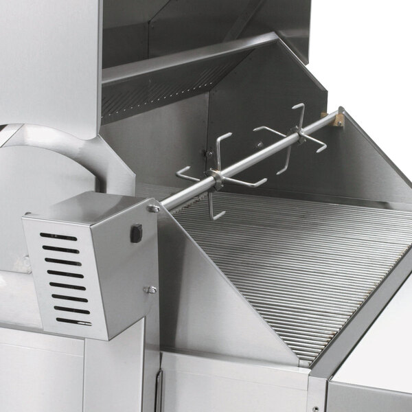 A close-up of a Crown Verity stainless steel rotisserie grill with two fork assemblies.
