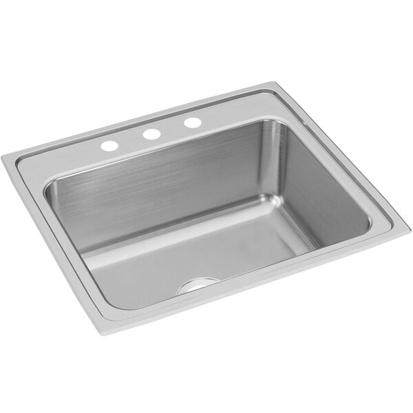 An Elkay stainless steel drop-in sink bowl on a counter.