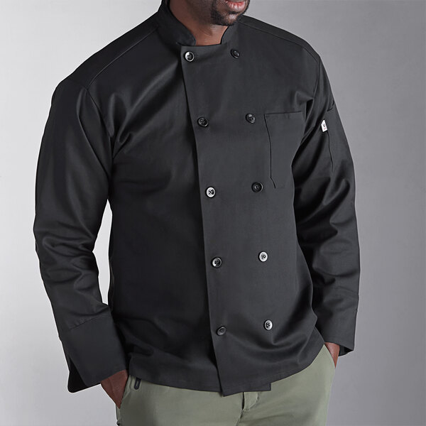 A man wearing a black Uncommon Chef long sleeve chef coat.