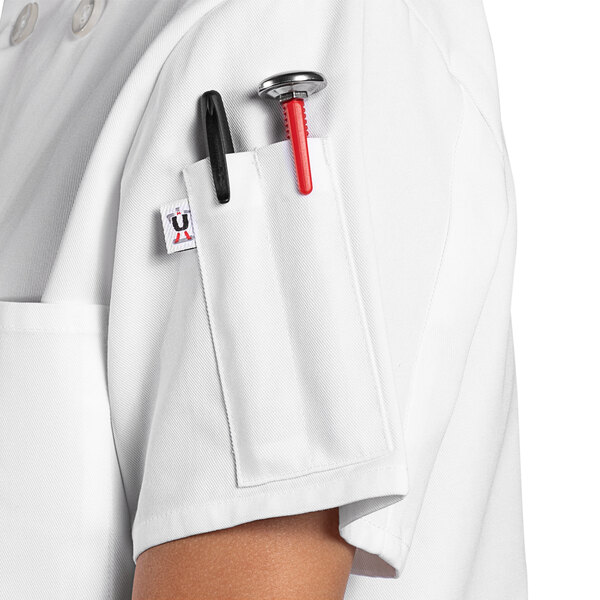 A Uncommon Chef white short sleeve chef coat with a red pen.