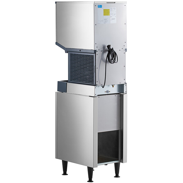 A Scotsman stainless steel ice machine with a water dispenser on a black base.