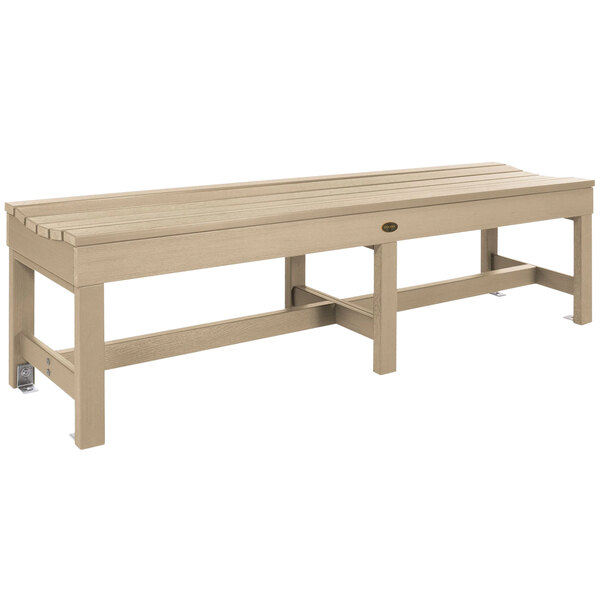A Tuscon taupe faux wood backless bench with legs.