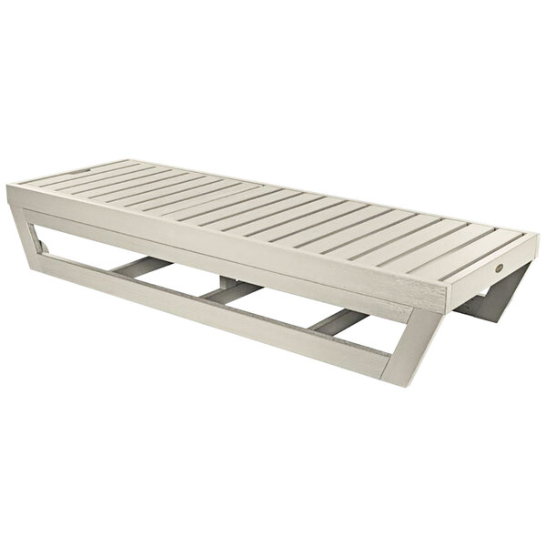 A white wooden chaise lounge with wooden slats.
