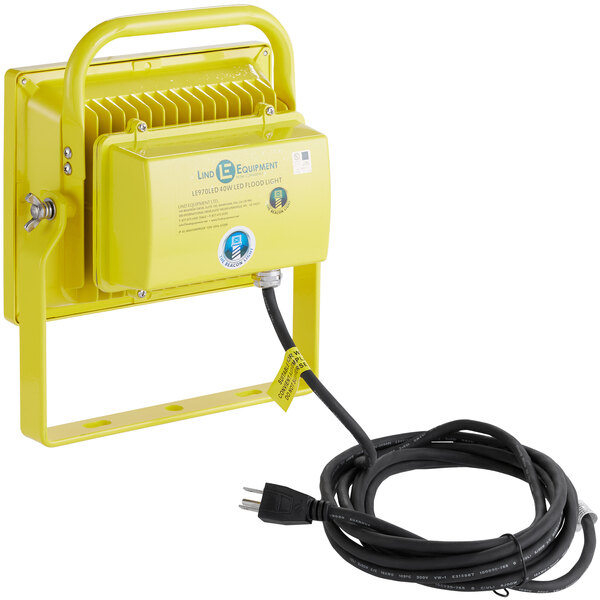 A yellow rectangular Lind Equipment LED floodlight with a black cord.