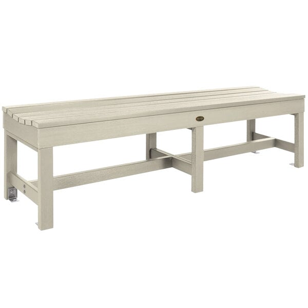 a white bench with a cross leg