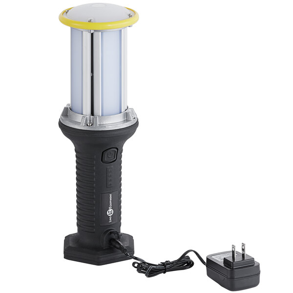 A black and white Lind Equipment Beacon360 portable hand lamp with a power cord.