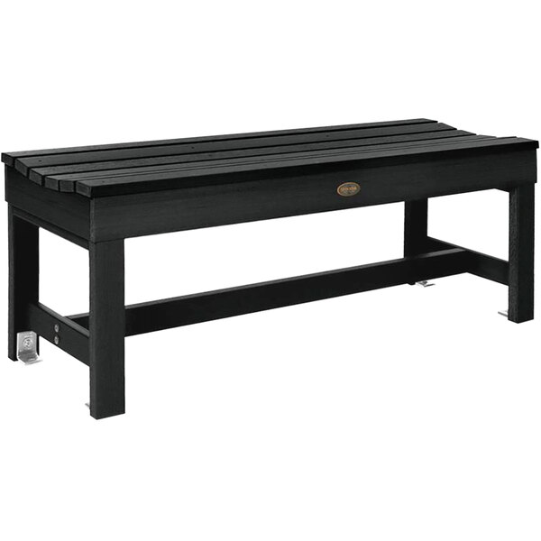 A black backless bench with a faux wood top.