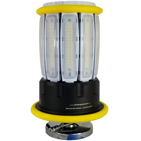A Lind Equipment Beacon360 Blaze LED portable area light with a yellow and black body and white base with magnets.