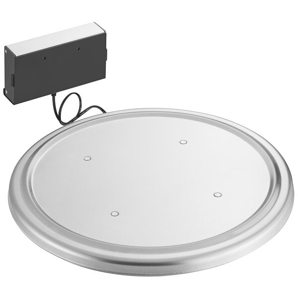 A round stainless steel platform with a black cord.