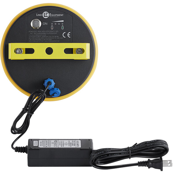 A yellow and black Lind Equipment Beacon360 GO portable area light with a power cord.
