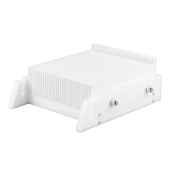A white rectangular device with vertical grooves, side supports, and two metal knobs on the front, resembling a kitchen or confectionery tool.