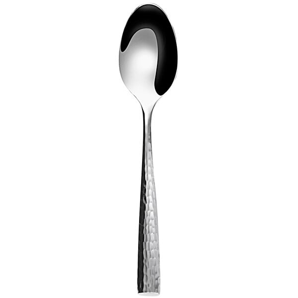 A Sola stainless steel dessert spoon with a black spot on the handle.