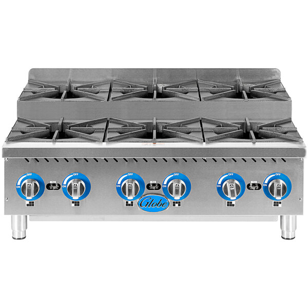 A close-up of a Globe countertop gas range with 6 burners.