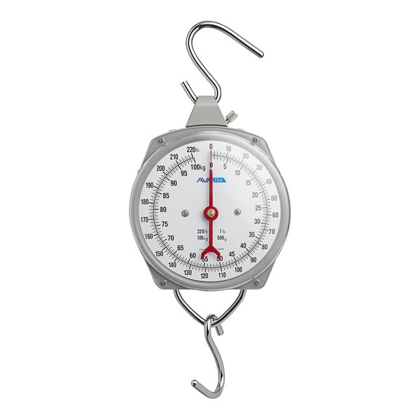 A round analog hanging scale with a metal hook at the top and bottom for weighing items.