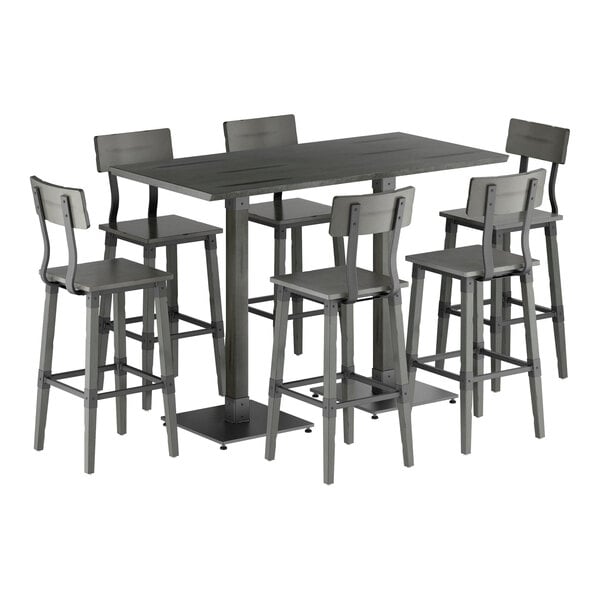 A rectangular bar-height table with a slate gray finish is surrounded by six matching bar stools, all featuring solid wood construction and a modern industrial design.