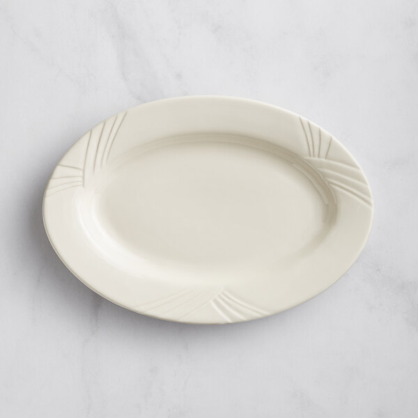An ivory Acopa stoneware oval platter with an embossed design.