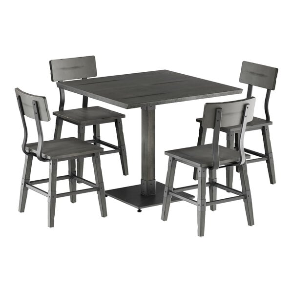 A Lancaster Table & Seating square slate gray dining table with four chairs around it.