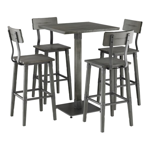 A Lancaster Table & Seating live edge bar height table with four bar stools.