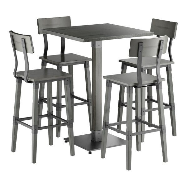 A square bar-height table with a slate gray finish is paired with four matching bar stools, all featuring solid wood construction and a modern industrial design.