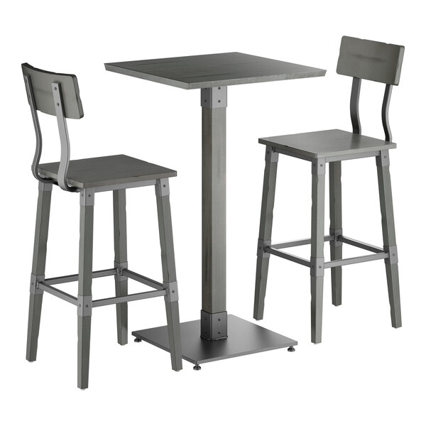 A bar-height table set with a square tabletop and two matching bar stools, all in a slate gray finish with metal accents and straight legs.