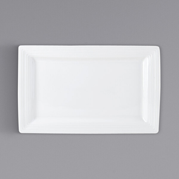 A white rectangular Tuxton Pacifica china plate with an embossed border.