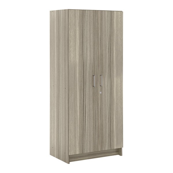 A Tot Mate Shadow Elm wooden tall cabinet with silver handles.