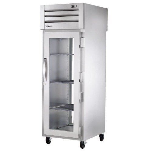 A True heated holding cabinet with glass doors and metal shelves.