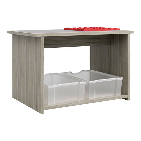 A Tot Mate Shadow Elm laminate preschool play center table with two plastic bins underneath.