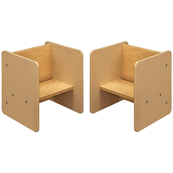 A beige and maple laminate activity cube with a wood surface and a shelf.