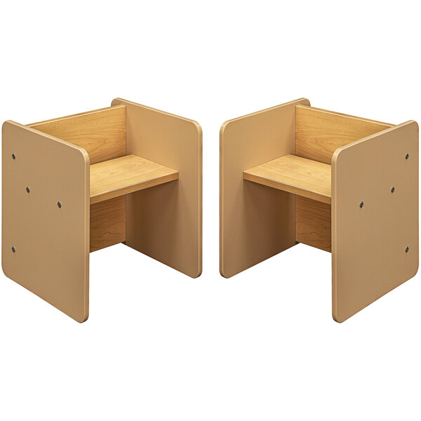 A pair of beige and maple wooden activity cubes with chairs.