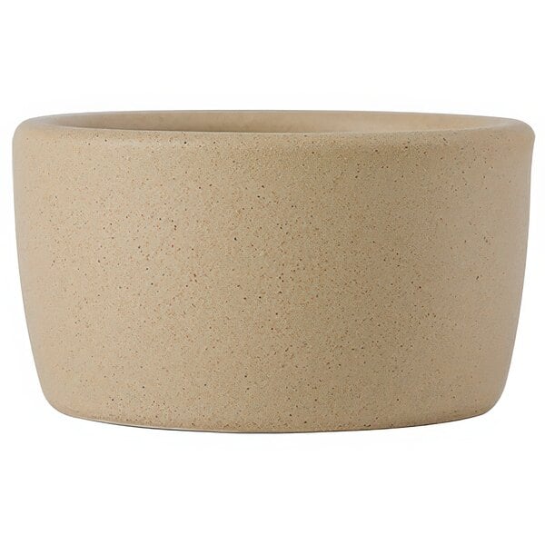 A Tuxton TuxTrendz beige ceramic ramekin with a handle.