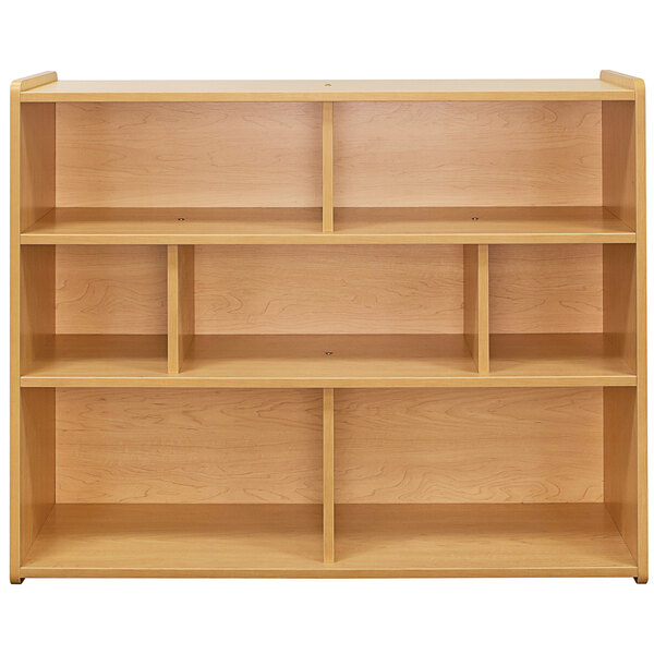 A Tot Mate maple laminate school age compartment storage unit with shelves.