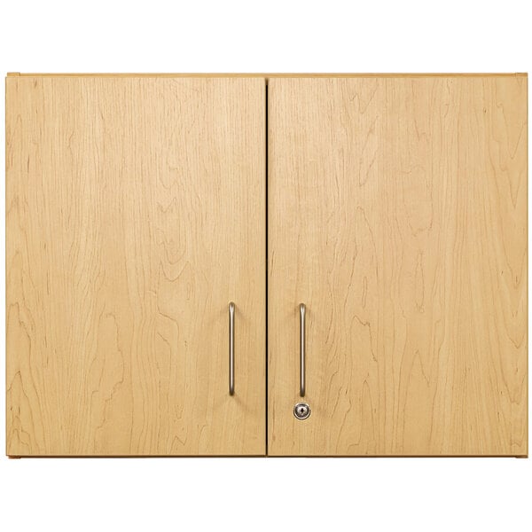 A Tot Mate maple wooden wall cabinet with two doors and handles.